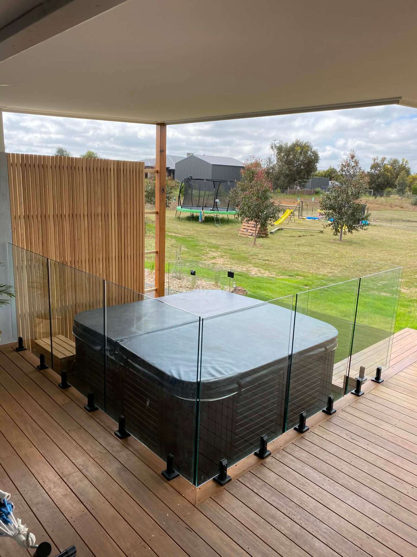 Glass fencing enclosing an outdoor spa