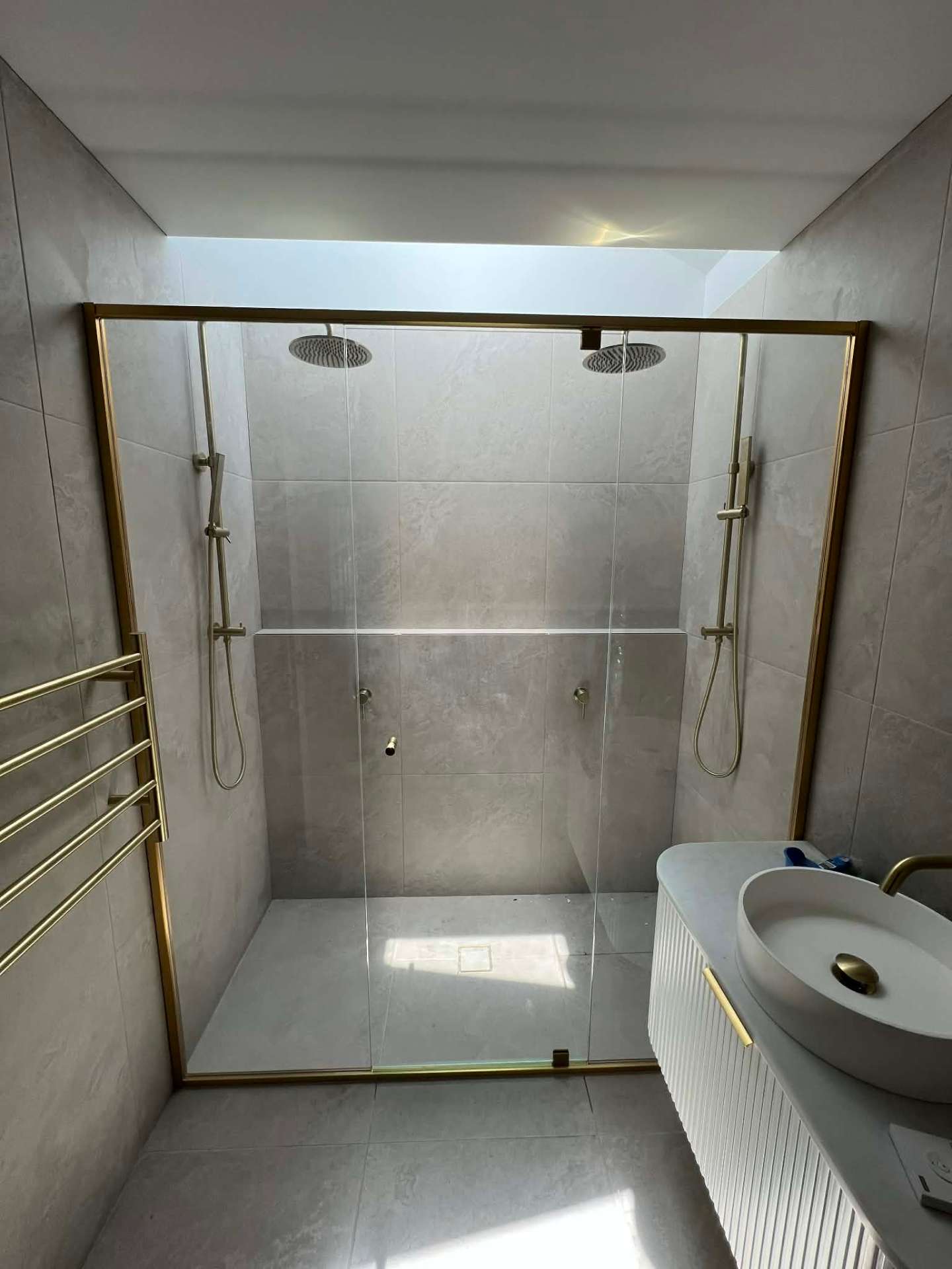 Gold framed double shower enclosure
