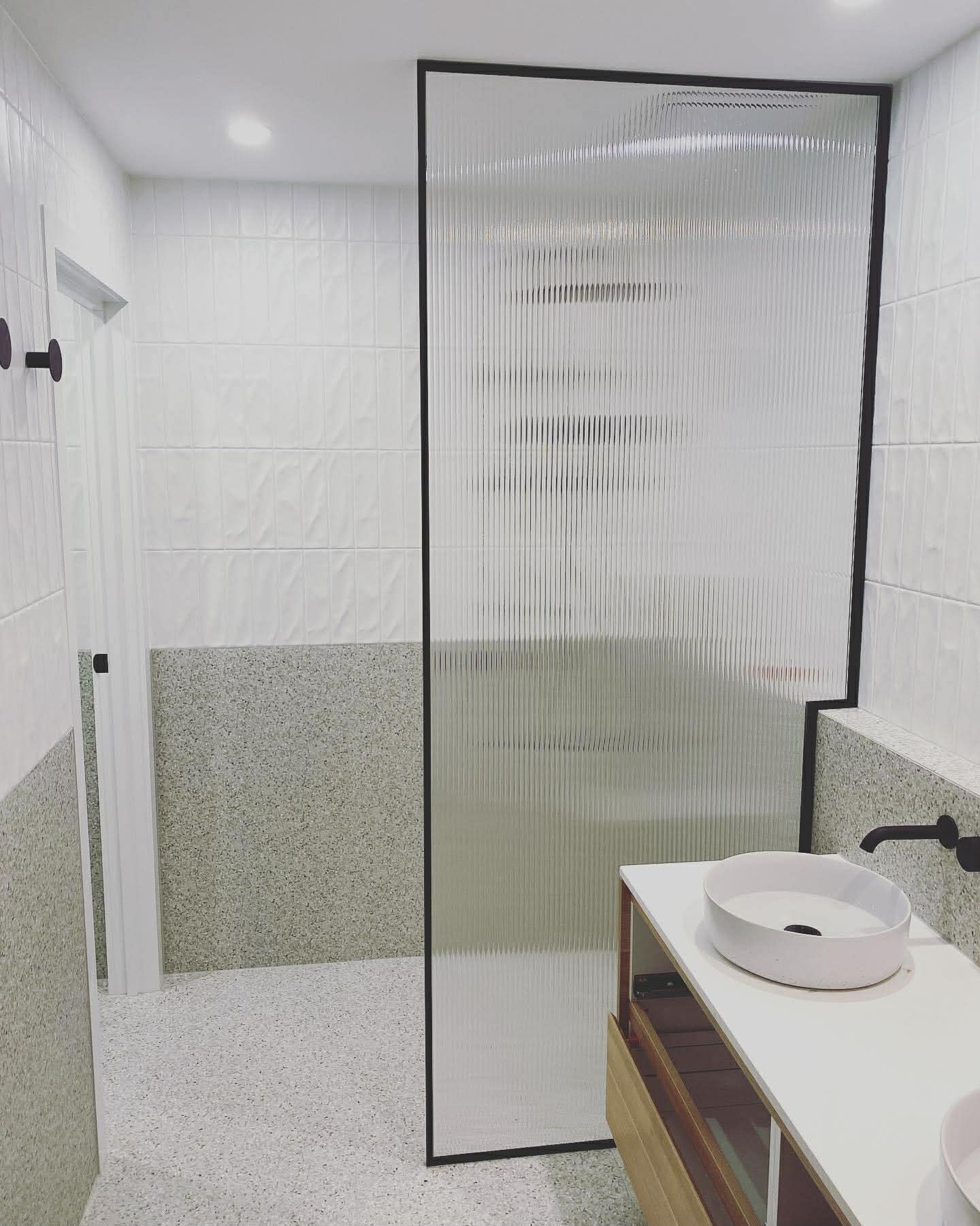 Black framed fluted glass shower screen
