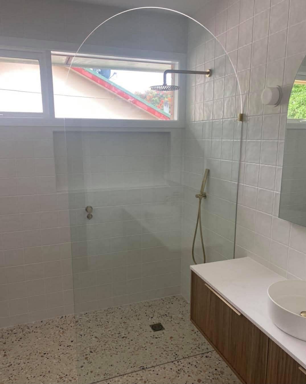 Frameless single panel shower with terrazzo floor