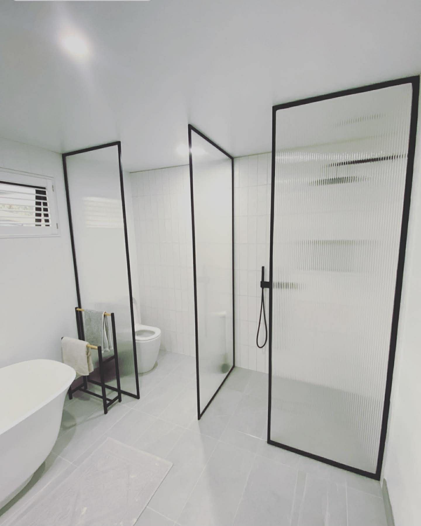 Black framed fluted glass shower partitions