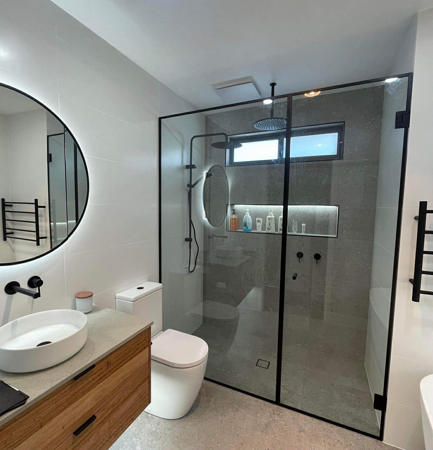 Black framed double shower with feature niche