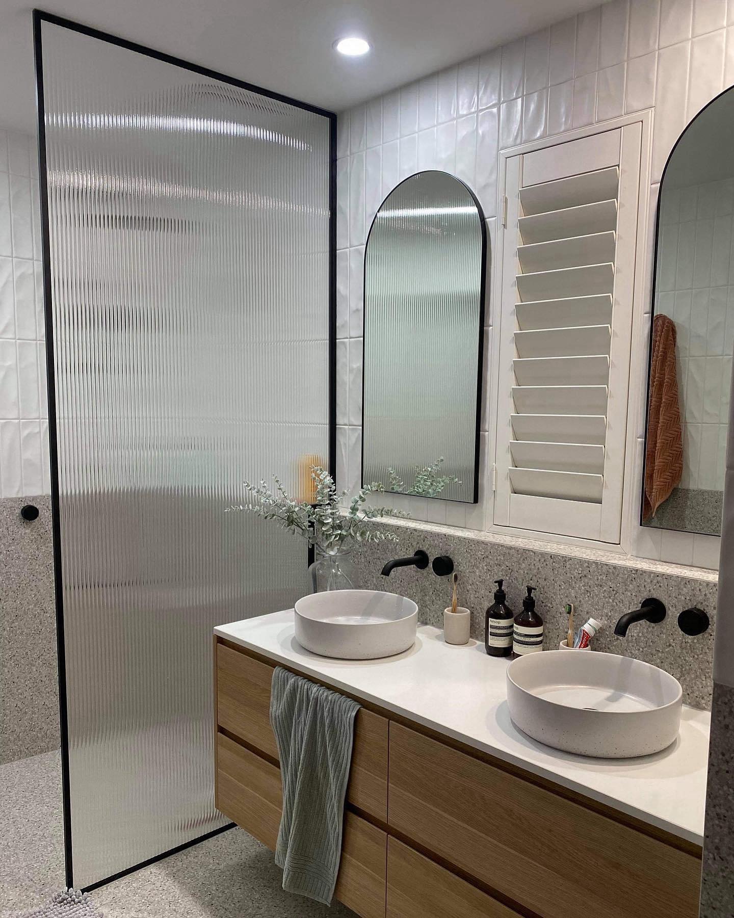 Fluted glass shower screen feature panel in a modern bathroom